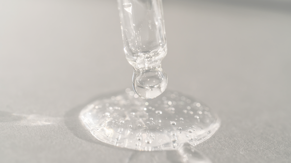 Oil dripping onto the surface from a dropper.