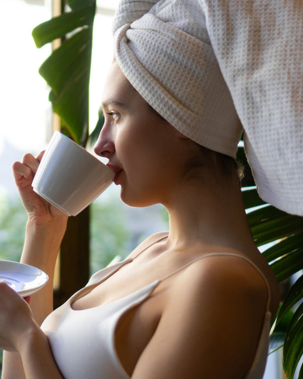 woman drinking coffee and looking outside 