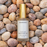 Bottle of Behrhaus fulvic acid barrier biome mist on a bed of stones