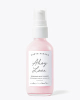 Earth Harbor Ahoy Love Nourishing Milky Cleanser in a pink glass pump bottle with a soft minimalist design on a white background.