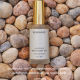 Behrhaus fulvic acid barrier biome mist bottle on pebbles with product description text.