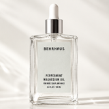 A dropper bottle of Peppermint Magnesium Oil in a glass travel friendly bottle