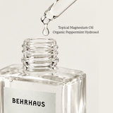A close up of Behrhaus Peppermint Magnesium Oil dropper dripping topical magnesium 
