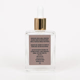 Back of Mini Behrhaus Vanilla Magnesium Oil bottle showing ingredients label on white. background