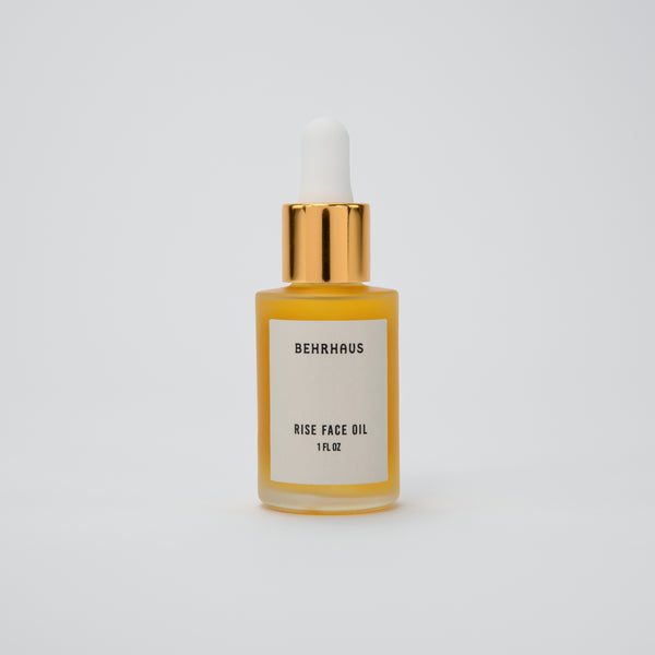 rise brightening face oil in a glass bottle with gold top