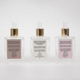 Back of Three Behrhaus magnesium oil bottles with gold droppers in Vanilla, Original, and rose on a white background.